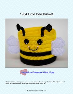 a crocheted basket with a smiling bee on the front and side, in black and yellow