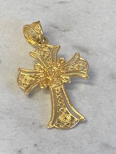 "A very unique 18kt Yellow Gold Lady's Cross Charm/Pendant consisting of a 3mm round Turquoise Gemstone bezel set in center with unusual high quality craftsmanship of open filigree design patterns that show on both sides making this cross reversible. The bail even is matching with open filigree. This Charm/Pendant measures 1 1/4\" in length and weighs 2.7 grams. This would make a beautiful Christening or Confirmation Gift. This item would Retail for $675.00" Elegant Jewelry With Intricate Design Cross Pendant, Yellow Gold Heart Pendant Jewelry, Gold Cross Jewelry With Intricate Design, Filigree Design Pattern, Gold Cross Pendant Jewelry With Intricate Design, Gold Cross Necklace With Filigree, Yellow Gold Cross Necklace With Large Pendant, Traditional Yellow Gold Cross Pendant Jewelry, Gold Intricate Cross Jewelry