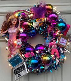 a barbie doll is sitting on top of a christmas ornament wreath with ornaments around it