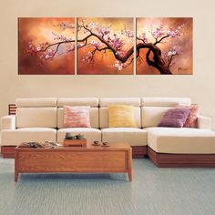 a living room with two paintings on the wall and a coffee table in front of it