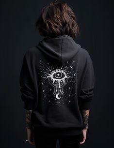 "If your size is not available, click this in the dropdown and select \"Let me know when it's back\" to get on the waitlist! Thank you for your patience and understanding! Get 10% off your first order: join.lucidamystica.com Mystical evil eye on a zip up unisex goth hoodie that's soft, cozy and warm for the colder months. Front of hoodie is blank. Plus sizes available for a roomy fit, size up for an oversized aesthetic look. Size chart found in images.  Perfect for yourself or as a gift for your Black Gothic Sweatshirt For Streetwear, Black Gothic Hooded Sweatshirt, Black Gothic Hoodie Sweatshirt, Gothic Hoodie With Graphic Print, Gothic Cotton Hoodie For Alternative Fashion, Black Gothic Hooded Hoodie, Gothic Hooded Hoodie For Alternative Fashion, Gothic Black Hoodie For Streetwear, Gothic Hooded Sweatshirt For Streetwear