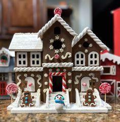 a gingerbread house decorated with candy canes and candies