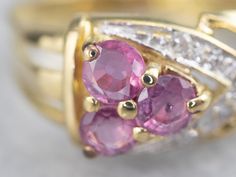 This vintage pink sapphire ring is ornate and feminine! The gracefully curving design draws the eye to the center, which is set with petal pink sapphires. Diamond accents enhance the sparkle of the ring and make this piece perfect for special occasions!Metal: 22K Yellow and White GoldGem: 3 Pink Sapphire totaling .42 CaratsGem Measurements: 3.2 mm, RoundAccents: 5 Diamonds totaling .05 Carats, SI1 in Clarity, G in ColorRing Size: 4.50 Sapphire And Diamond Ring, Pink Sapphire Ring, Arrow Design, Color Rosa, 22k Gold, Pink Sapphire, Designs To Draw, Vintage Pink, Ring Designs