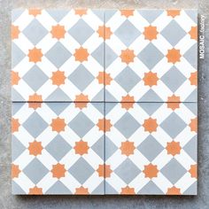 an orange and gray tile pattern on the ground