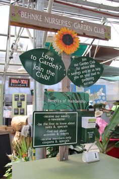 a sign that says love to garden join the club in front of some plants and flowers