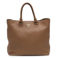 This Prada Women's Brown Vitello Phenix Leather Shopping Tote is the perfect bag to shop and run your errands with. Prada's luxurious Vitello Phenix handbag is the ideal designer tote for carrying all of your belongings in. There is plenty of storage space to store your personal items. There are three interior pockets and the snap closure makes it easy to access your belongings. This is also a great travel handbag to carry on trips or airplanes when you are on the go. This is such a classic Prad Travel Handbag, Prada Collection, Versus Versace, Luxury Sale, Travel Handbags, Handbag Organization, Designer Totes, Diamond Shop, Leather Shops