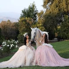 two beautiful women in dresses sitting next to a horse