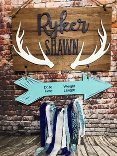 a wooden sign that says riley shawn with two arrows hanging from it's sides