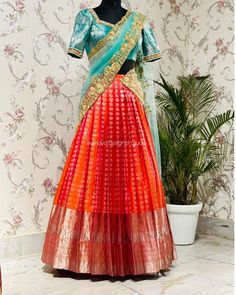 an orange and blue lehenga with gold work on the blouse, skirt and dupatta