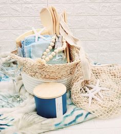 Coastal Kitchen New Home Gift Basket by Beach Hustle We believe that every new home deserves a thoughtful gift box filled with essentials for a beautiful and functional kitchen,  Our New Home Gift Basket includes a natural woven basket for storage, a set of bamboo kitchen utensils, an 8 inch bamboo cutting board, 2, cotton kitchen hand towels, 16oz reusable hand soap jar, eco-friendly cotton fruit bag, natural wood bead decor, 2, silver sea turtle wine glass charms, 16oz hand-poured soy candle. Ingredients and more: Woven Basket- use this for storage in any room. Hand Soap- 100% coconut oil soap with natural fragrance.  Ocean Rain/ refill this with your favorite hand soap. Bamboo Utensils-  natural bamboo/ hand wash/ air dry/  Bamboo Cutting Board-  hand wash/ air dry/ perfect size for cut New Home Basket, New Home Gift Basket, Candle Ingredients, Ocean Rain, Bamboo Kitchen Utensils, Coconut Oil Soap, Bamboo Kitchen, Fruit Bag, Bead Decor