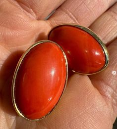 --Stone(s):-- (2) Natural Genuine Corals - Oval Cabochon Cut - Bezel Set -  Reddish Orange Color - 28.94ctw (exact, certified) ** See Certification Details Below for Complete Info ** Material: Solid 18k Yellow Gold Weight: 11.58 Grams Backing: Posts w/ Omega Closures (Pierced ears are required.) Length: 23.5mm (0.92") Width: 15.4mm (0.60") Thickness: 8.9mm (at the coral) projection off the ear Condition: Vintage stones. New earrings. Comes with the original GIA certification for both of the cora Classic Oval Cabochons For Anniversary, Oval Yellow Gold Cabochons For Formal Events, Oval Cabochons For Formal Wear Fine Jewelry, Classic Oval Gemstone Cabochons, High Luster Oval Gemstones For Gifts, Luxury Red Oval Earrings, Elegant Red Polished Gemstones, Oval Polished Cabochons For Gifts, Elegant Red Cabochon Gemstones