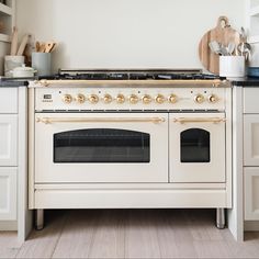 a white stove top oven sitting inside of a kitchen