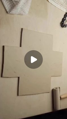 a video demonstrating how to cut out pieces of paper with scissors and glue on the wall