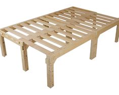 a wooden bed frame sitting on top of a white floor next to a table with two legs