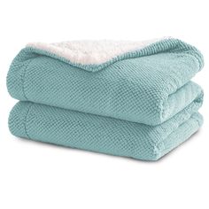 two towels stacked on top of each other in aqua blue and white colors, one is folded