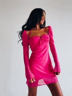 DETAILS: Our Tayla Long Sleeve Dress In Magenta is an A-line dress with long sleeves and emphasised bustline. This dress features lightweight semi sheer sleeves that are fitted with wider cuff detail. The bust/neckline of this dress features a self tie halter neckline, boning underneath the bust for additional support, and self tie knotted detail. This dress is compleated with a back zipper closure with a hook and eye clasp. This dress is fully lined all throughout and is true to size. CONTENT & Long Sleeve Dresses With Sheer Sleeves For Brunch, Flirty Dress With Sheer Long Sleeves, Flirty Dress With Long Sheer Sleeves, Flirty Dresses With Sheer Long Sleeves, Chic Fitted Long Sleeve Dress With Bell Sleeves, Flirty Long Sleeve Dresses With Sheer Sleeves, Long Sleeve Dress With Gathered Sleeves For Brunch, Flowy Long Sleeve Dress With Gathered Sleeves, Spring Mini Dress With Sleeves