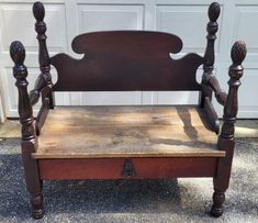 an old wooden chair sitting in front of a garage door