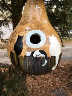 a bird house with two cats painted on it