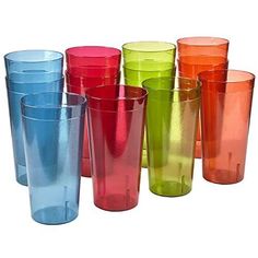 many different colored glass cups are lined up in a row on a white background,