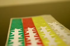 a close up of some stickers on a table with the colors red, yellow and green