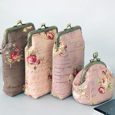 three purses are lined up next to each other with writing on them and flowers