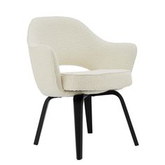 an upholstered white chair with black legs