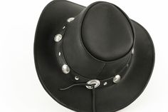 Our leather cowboy hats are genuine cowhide leather. This beautifully handcrafted hat is made with fine craftsmanship and materials. Any scars, wrinkles or other subtle variations are characteristics of natural leather and do not affect its strength or quality. The unisex leather hat is embellished with buffalo studs around it. Use the strap for windy days or to keep it around your neck while traveling so you won't lose it. Perfect accessory for men and women. Please refer to the measurement cha Black Western Top Hat For Rodeo, Western High Crown Top Hat For Ranch, Black Western Top Hat For Outdoor, Black Western Top Hat For Ranch, Western Style Black Top Hat For Western-themed Events, Black Western Style Top Hat For Ranch, Black Western Hat For Riding, Black Western Riding Hat, Western Style Concho Hats For Country Events