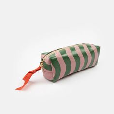 Ideal as a large pencil case or a small cosmetics bags to keep you make up safe and secure, this case is made from leather look PU and comes in our new pink and green wave stripe design. Leather look PU Ideal as a pencil case or cosmetics bag Size: H 50 x L 200 x D 75mm About the designer: Caroline Gardner is best known as one of the UK's leading and most prolific accessory, gift and stationery designers. Her distinctive designs now stretch across various product categories, including paper, acc Pink Rectangular Pouch With Pen Holders, Rectangular Pink Pouch With Pen Holders, Pink Rectangular Pencil Case With Zipper, Rectangular Pink Pencil Case With Zipper, Green Rectangular Travel Pencil Case, Trendy Pink Rectangular Pouch, Green Pencil Case Pouch For Daily Use, Green Pouch Pencil Case For Daily Use, Pink Cosmetic Bag With Pen Holders For Daily Use