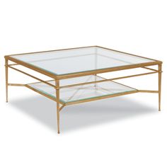 a coffee table with glass top and gold metal frame on an isolated white background,