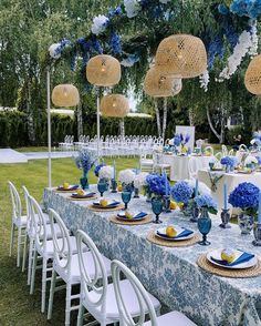 a table set up with blue and white decorations