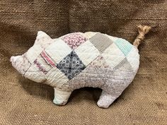 Little Piggy front made from an antique quilt, backing is new cotton material.  Stuffed with new professional polyester filling ( polyfil ).   Size: 10 inches Head to Tail ↔️  x 7 inches Back to Hoof ↕️ Old quilt has been washed multiple times to achieve the most cleanest condition.  Being that it is vintage/antique, hilt material may have imperfections such at stains or loose threads.  This adds to the character of the fabric.  Any holes will be reinforced.   My creations are all original, no t Quilt Pillow, Quilt Backing, Old Quilts, Antique Quilt, Vintage Quilt, Bowl Fillers, Quilted Pillow, Shelf Sitter, Vintage Quilts