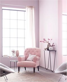 a living room with pink walls and furniture