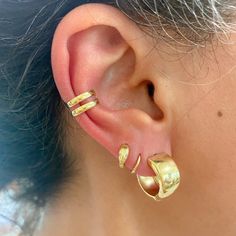 "This thick huggie hoop earring is composed of 14K solid gold and features a secure hinged closure for the ease of taking them on and off.  ♦ Huggie Dimensions:         - outer diameter: approximately 17.6mm         - inner diameter: approximately 12.5mm        - hoop width: approximately 8mm        - post thickness: 0.8mm         - post length: 7mm ♦ Weight: approximately 4 grams of 14K solid gold for the pair ♦ Metal Finish: High Shine Polish ♦ This design is currently available in 14K Yellow Yellow Gold Huggie Wrap Earrings, Hypoallergenic Yellow Gold Huggie Ear Cuff, Gold Huggie Ear Cuff With Matching Earrings, Clip-on 14k Gold Huggie Earrings, Gold Huggie Ear Cuff For Anniversary, 14k Gold Clip-on Huggie Earrings, Ear Types, Gold Ear Cuff, Ear Cuffs