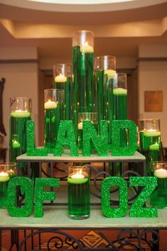 green candles are arranged in the shape of letters and numbers