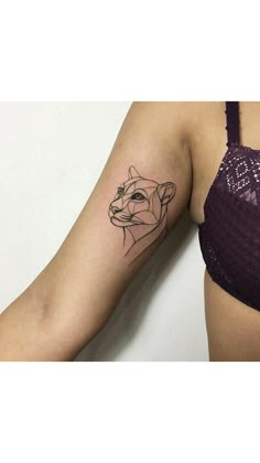 a woman's arm with a tattoo on it and an image of a bear