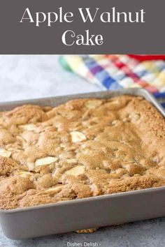 an apple walnut cake in a pan on a table with the words, how to bake an apple walnut cake