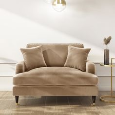 a living room with a couch and two lamps on the side tables in front of it