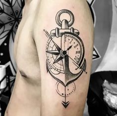 a man's arm with an anchor, compass and clock tattoo on the side