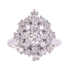 Vintage American diamond cluster white gold ring, circa 1950. This 14 karat white gold ring features a cluster of diamonds. The center round brilliant cut diamond is .25 carat surrounded by 25 round brilliant cut diamonds at .88 carat total weight. All diamonds have VS-SI clarity and G-H color. Total diamond weight is 1.13 carats. This diamond cluster ring is a size 6. Item #EROS D810 Classic Cluster Diamond Ring In Platinum, Classic Platinum Cluster Diamond Ring, Vintage White Cluster Diamond Ring, Platinum Cluster Ring In White Gold, Platinum White Gold Cluster Ring, Cluster Diamond Ring In 14k White Gold, White Platinum Cluster Ring With Single Cut Diamonds, Dazzling Cluster White Gold Diamond Ring, Fine Jewelry Diamond White Cluster Diamond Ring