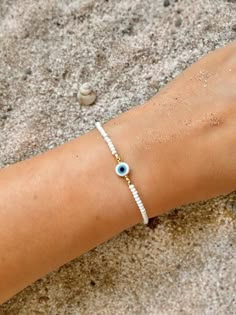 White Evil Eye Bracelet Dainty Evil Eye Bracelet Beaded Evil | Etsy Evil Eye Seed Bead Bracelet, Sea Bead Bracelets, Evil Eye Bracelet Ideas, Evil Eye Bracelet Diy, White Evil Eye Bracelet, Evil Eye Jewelry Bracelet, Evil Eye Beaded Bracelet, Beaded Evil Eye, White Evil Eye