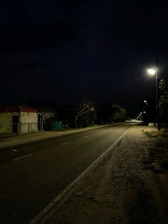 an empty street at night with the lights on