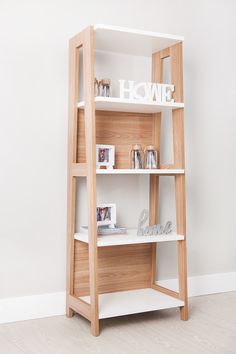 a wooden shelf with books and pictures on it