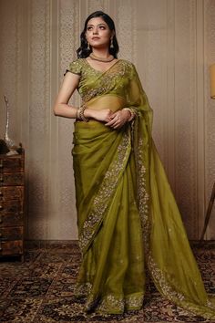 Mehendi green silk organza saree with floral embroidered borders. Comes with blouse.
Component: 2
Pattern: Embroidery
Type Of Work: Cutdana, Bead and Sequin
Neckline: Scoop
Sleeve Type: Cap
Fabric: Saree: Pure Silk Organza and Blouse: Satin Silk
Color: Green
Other Details: 
Blouse with all-over embroidery
Closure: Back hook
Occasion: Wedding - Aza Fashions Bottle Green Saree, Blouse Satin, Border Saree, Embroidered Border, Stylish Blouse Design, Green Saree, Saree Trends, Contrast Blouse, Satin Blouses