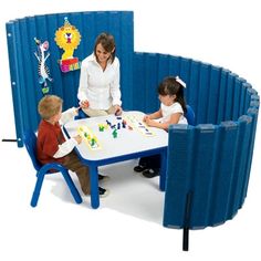 a woman and two children sitting at a table with a board game in front of them