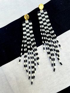 These fun, fringe, seed bead dangle earrings feature a black and white colored checkerboard pattern and are made with size 11 miyuki seed beads. The closure is a gold plated stainless steel post with safety back. They hang approximately 4.5 inches from the lobe and measure 0.75" inches across their widest point.Each pair is made to order and handmade. Each earring takes several hours to complete as each bead is stitched together, one by one, using beadwork stitch techniques. Stitch Techniques, Bead Dangle Earrings, Beading Jewelery, Blue Sodalite, Coral And Gold, Steel Post, Checkerboard Pattern, Bone Beads, Beaded Dangle Earrings