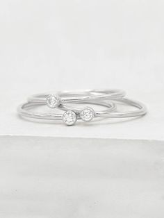 "The 1mm CZ stacker is part of my dainty stacker collection. The ring is a 1mm sterling silver ring with a 2mm stone in a bezel setting. It's super thin and has a \"barely\" there look! It's great for everyday wear. In the case it tarnishes, it can easily be cleaned with sterling silver cleaner/polish. Please read my shop policies to learn more about the composition and proper care for each item purchased. All plated jewelry from our shop are eligible for our jewelry restoration program. For mor Minimal Silver Ring, Ring Minimal, Sterling Silver Cleaner, Silver Cleaner, Sterling Silver Stacking Rings, Midi Ring, Silver Stacking Rings, Midi Rings, Pinky Ring