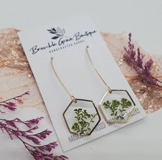 the earrings are made with pressed flowers and gold plated earwires on them