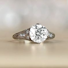 an old - fashioned diamond ring is displayed on a table