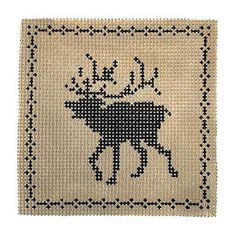 a cross stitch pattern with a moose on it's back and black dots in the middle