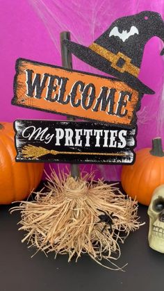 a welcome sign with a skeleton and pumpkins